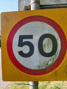 Dirty 50MPH Road sign