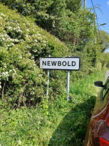 Visible sign next to hedge